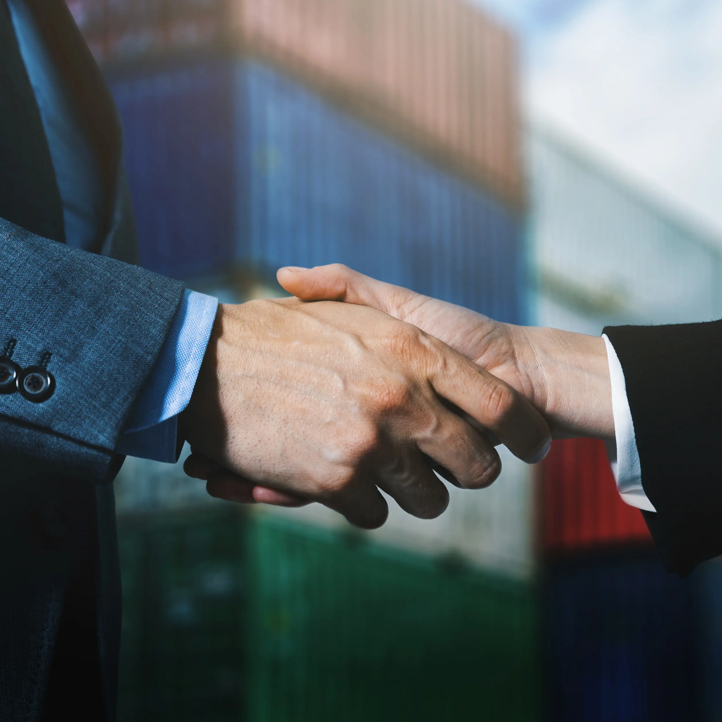 Man and woman shaking hands at rail yard